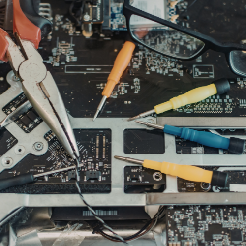 Apple Mac logic board repair bench with precision tools.