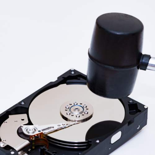 Symbolic image of physical destruction of a hard drive (actual methods vary by agreement).